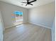 Bright bedroom featuring wood-look flooring and a window with a view at 1131 Lupin St, Pahrump, NV 89048