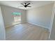 Clean bedroom featuring wood-look flooring and a bright, sunlit window at 1131 Lupin St, Pahrump, NV 89048