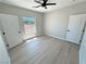 This bedroom features two closets, wood-look floors, and a window with natural light at 1131 Lupin St, Pahrump, NV 89048