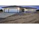 Charming single-story home featuring a three-car garage, arched entryway, and desert landscaping at 1131 Lupin St, Pahrump, NV 89048
