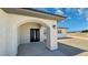 Inviting front entrance with a modern black door and arched entryway, enhancing curb appeal at 1131 Lupin St, Pahrump, NV 89048