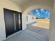 Inviting front entrance with a modern black door and arched entryway, enhancing curb appeal at 1131 Lupin St, Pahrump, NV 89048