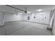 Three car garage features ample space, white walls and doors, plus lighting at 1131 Lupin St, Pahrump, NV 89048