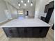 Stunning kitchen island with a marble countertop and stylish dark cabinets, opening into the living area at 1131 Lupin St, Pahrump, NV 89048