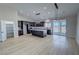 Modern kitchen features dark cabinets, light countertops, and a center island open to living space at 1131 Lupin St, Pahrump, NV 89048