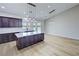 Spacious kitchen features a large island, dark cabinets, light countertops and stainless steel appliances at 1131 Lupin St, Pahrump, NV 89048