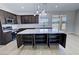 Spacious kitchen island with marble countertop and sleek dark cabinets, complemented by stainless steel appliances at 1131 Lupin St, Pahrump, NV 89048