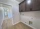 Functional laundry area with dark cabinets, and washer/dryer hookups at 1131 Lupin St, Pahrump, NV 89048