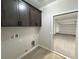 Laundry area features cabinets, washer/dryer hookups, and garage access at 1131 Lupin St, Pahrump, NV 89048