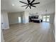 Open-concept living room showcasing vaulted ceilings, wood flooring, and seamless flow into the kitchen at 1131 Lupin St, Pahrump, NV 89048
