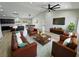 Staged living room with modern furniture, hardwood floors, and open floor plan to kitchen and dining areas at 1131 Lupin St, Pahrump, NV 89048