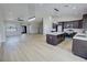 Bright living room showcasing hardwood floors, recessed lights, and open layout to the kitchen with dark cabinets at 1131 Lupin St, Pahrump, NV 89048