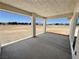 A covered patio features a concrete floor and views of the surrounding landscape and mountains in the distance at 1131 Lupin St, Pahrump, NV 89048