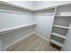 This spacious walk-in closet features custom shelving and wood-look floors, offering ample storage at 1131 Lupin St, Pahrump, NV 89048