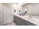 Bathroom featuring double sinks with gray cabinets and a large mirror at 1301 Miller Springs Ln # Lot 93, North Las Vegas, NV 89084
