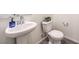 Bright powder room with a pedestal sink, toilet, and mirrored wall at 1301 Miller Springs Ln # Lot 93, North Las Vegas, NV 89084