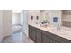 Bright bathroom with double sinks, quartz countertops, and stylish gray cabinets at 1301 Miller Springs Ln # Lot 93, North Las Vegas, NV 89084