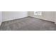 Large bonus room with plush gray carpet, neutral paint, and window at 1301 Miller Springs Ln # Lot 93, North Las Vegas, NV 89084
