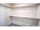 Walk-in closet featuring built-in shelving and plush carpet at 1301 Miller Springs Ln # Lot 93, North Las Vegas, NV 89084