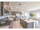 Modern kitchen with stainless steel appliances, gray cabinetry, and a central island with sink at 1301 Miller Springs Ln # Lot 93, North Las Vegas, NV 89084