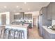 Modern kitchen with stainless steel appliances, gray cabinetry, a center island with seating, and tile floors at 1301 Miller Springs Ln # Lot 93, North Las Vegas, NV 89084