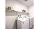 Bright laundry room featuring a white washer and dryer at 1301 Miller Springs Ln # Lot 93, North Las Vegas, NV 89084