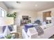 Comfortable living room with stylish decor, tile flooring, a cozy sofa, and a view into the dining area at 1301 Miller Springs Ln # Lot 93, North Las Vegas, NV 89084