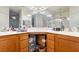 Bathroom showcasing double sinks, wooden drawers, a big mirror, and ample counter space at 135 Manor House Ave, Las Vegas, NV 89123