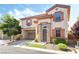 Charming two-story home featuring stucco siding, decorative shutters, and a convenient attached two-car garage at 135 Manor House Ave, Las Vegas, NV 89123