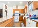 Functional kitchen featuring oak cabinets, a center island, and modern appliances for convenient meal preparation at 135 Manor House Ave, Las Vegas, NV 89123