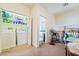 Convenient laundry room with a washer, a dryer, and adjacent living space at 135 Manor House Ave, Las Vegas, NV 89123