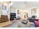 Spacious living room with access to stairs, neutral carpeting, and a cozy atmosphere for relaxation and entertainment at 135 Manor House Ave, Las Vegas, NV 89123