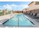 Community pool and jacuzzi with lounge chairs and shaded seating area at 135 Manor House Ave, Las Vegas, NV 89123