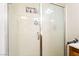 Bathroom featuring a glass shower with shelves, lights, and ample space for essentials at 135 Manor House Ave, Las Vegas, NV 89123