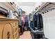 Carpeted walk-in closet featuring a wooden dresser and wire shelving for easy organization at 135 Manor House Ave, Las Vegas, NV 89123