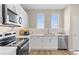 Well-lit kitchen with white cabinets, stainless steel appliances, and a modern backsplash at 137 Harmonica Ave # Lot 19, Henderson, NV 89015
