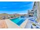 Serene backyard setting with a refreshing pool, comfortable lounge chairs, and lush landscaping at 1523 Great Sands St, Boulder City, NV 89005