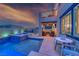 Backyard retreat featuring a pool, jacuzzi, and outdoor seating area with a grill and comfortable lounge furniture at 1523 Great Sands St, Boulder City, NV 89005