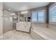Elegant bathroom featuring soaking tub, shower, and marble tile flooring at 1523 Great Sands St, Boulder City, NV 89005
