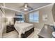 Cozy bedroom with a black bed frame, shuttered windows, and stylish decor at 1523 Great Sands St, Boulder City, NV 89005