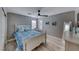 Comfortable bedroom featuring wood-look floors, a ceiling fan and white wood bed frame with blue accents at 1523 Great Sands St, Boulder City, NV 89005