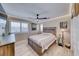 Cozy bedroom showcasing wood-look floors, ceiling fan, and a wooden bed frame at 1523 Great Sands St, Boulder City, NV 89005