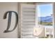 Bedroom detail with window shutters, lamp, and view of mountains in the distance at 1523 Great Sands St, Boulder City, NV 89005