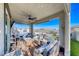 Inviting covered patio with comfortable seating, ceiling fan, and view of the pool at 1523 Great Sands St, Boulder City, NV 89005