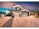 Charming two-story home featuring a three-car garage and brick paved driveway at 1523 Great Sands St, Boulder City, NV 89005