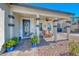 Covered front porch with chairs, a ceiling fan, and decorative plants at 1523 Great Sands St, Boulder City, NV 89005