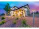 Landscaped front yard featuring a covered porch with a seating area, providing a welcoming entrance to the home at 1523 Great Sands St, Boulder City, NV 89005