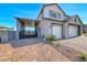 View of the exterior with a three-car garage, covered car port, and desert landscaping at 1523 Great Sands St, Boulder City, NV 89005
