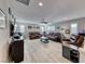 Spacious living room featuring leather furniture, a ceiling fan, and wood-look floors at 1523 Great Sands St, Boulder City, NV 89005