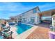 Expansive backyard featuring a private pool, jacuzzi, lounge area and outdoor kitchen setup at 1523 Great Sands St, Boulder City, NV 89005